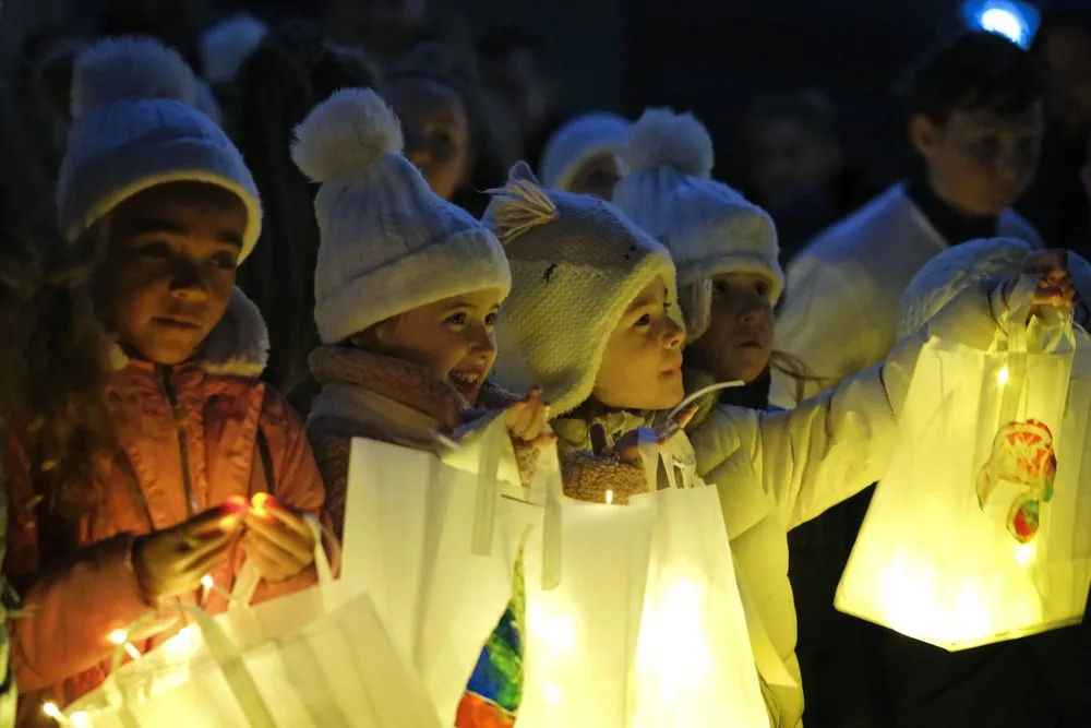Children carrying handmade lanterns at the Unwrapped Winter Festival