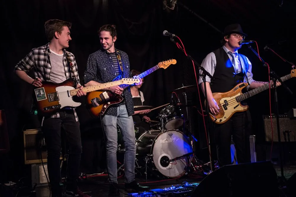 Young band performing onstage at The Grand Social