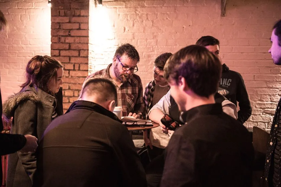 A mentor and young musicians working together at a SubSounds session